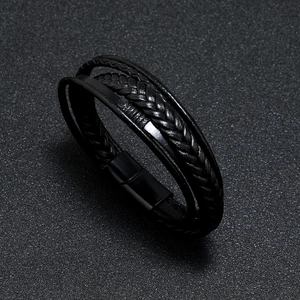 Close-up of black braided leather multi-layer bracelet with a matte magnetic buckle