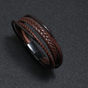Detail of multi-layer brown braided leather bracelet with black magnetic clasp for men