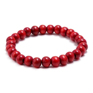Close-up of ethnic red beaded bracelet featuring round wooden beads and elastic cord