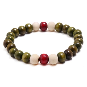 Detailed close-up of ethnic wood bead bracelet with olive green and red wooden beads