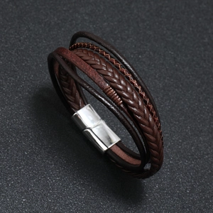 Detailed close-up of woven brown leather strap with polished silver magnetic clasp
