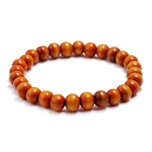 Detailed macro view of polished round wooden beads with natural grain on elastic bracelet