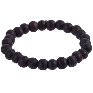 Macro shot of ethnic style deep purple wood beads with natural grain and zen texture
