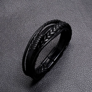 Macro detail of multi-layered braided leather bracelet with black magnetic metal clasp