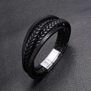Detailed view of multilayer braided leather men's bracelet with silver magnetic clasp