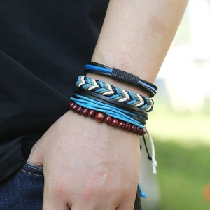 Détail de bracelets multi-rangs en cuir avec cordes tressées et perles en bois au poignet