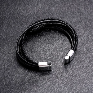 Detail shot of multi-layer black braided leather cord bracelet with silver magnetic metal clasp