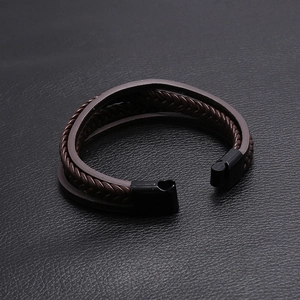 Close-up of multilayer dark brown braided leather bracelet with black magnetic clasp