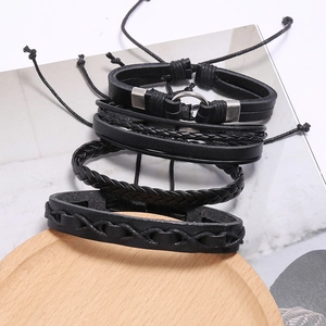 Set of four black braided leather bracelets for men featuring ethnic and vintage cord styles