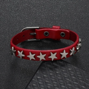 Detail view of red leather punk bracelet with silver star metal rivets and buckle
