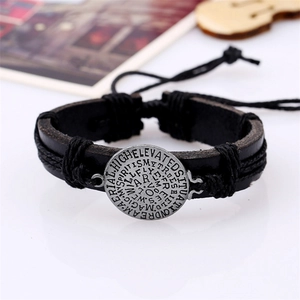 Vintage black braided leather cross bracelet featuring a round silver engraved medal charm