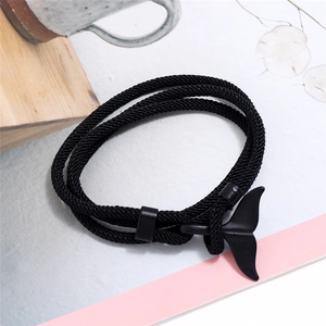 Dettaglio del bracciale in corda intrecciata nera multistrato con ciondolo a coda di balena