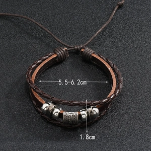 Macro detail of men's braided leather bracelet with vintage metal beads and size dimensions