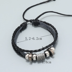Detail showing the adjustable leather weave with metal beads and vintage engraved cylinders