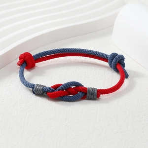 Detail of red and blue braided couple bracelets with adjustable sliding knot closure