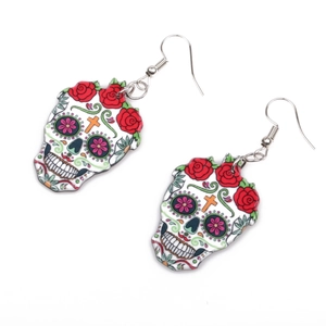 Detail of Day of the Dead skull earrings with red roses and silver hooks on white background