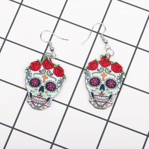 Detail of acrylic Day of the Dead sugar skull earrings with red rose pattern and colorful art