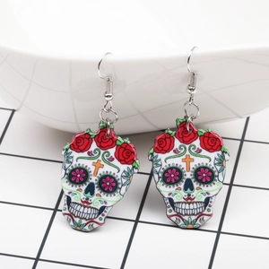 Detail view of colorful acrylic Calavera skull earrings with red roses for Day of the Dead