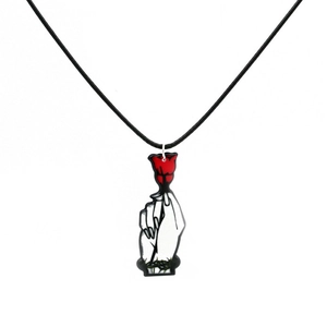 Detail of gothic acrylic necklace featuring a hand holding a red rose with thorns