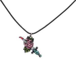 Macro shot of Gothic enamel pink rose pendant pierced by a blue dagger on black rope