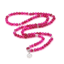Detailed shot of Tree of Life necklace with rose pink beads and silver lotus pendant