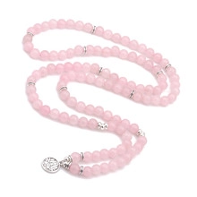 Detail showing long pink crystal bead necklace with silver lotus pendant and spacers
