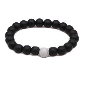 Detailed macro view of 8mm lava rock beads and white turquoise on elastic bracelet