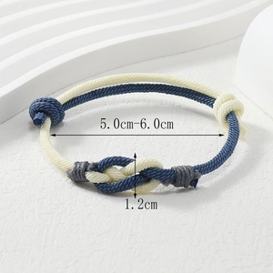Detailed close-up of blue and white woven knot bracelet showing adjustable sliding knots