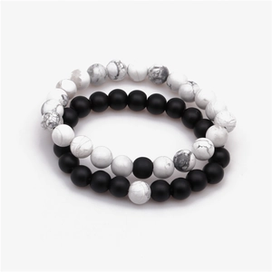 Detailed macro of 8mm lava rock and turquoise bead bracelets with matte black and white marble