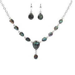 Macro detail of teardrop-shaped abalone shell necklace and matching earrings set