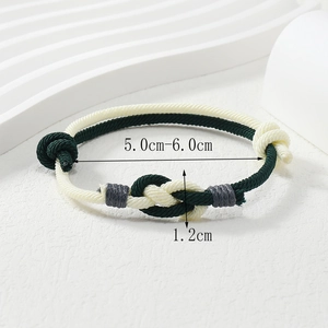 Close-up of handmade woven rope bracelet in green and cream with size measurements