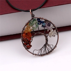 Macro detail of Tree of Life pendant with seven chakra stones and copper wire wrapping