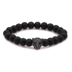 Close-up of matte black beads and gunmetal leopard head charm with green zircon eyes