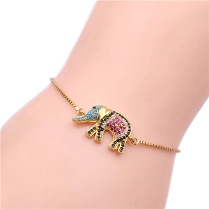 Close-up of golden elephant charm bracelet with colorful cubic zirconia and adjustable chain