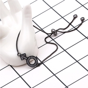 Detail of gunmetal bolo bracelet featuring a micro-paved zircon male symbol charm