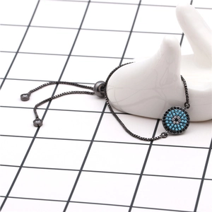 Detail of evil eye slider bracelet with black metal and micro-pave blue cubic zirconia