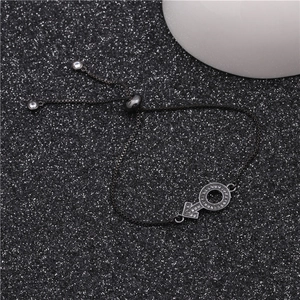 Detail of adjustable black chain bracelet with zircon-encrusted Mars symbol charm