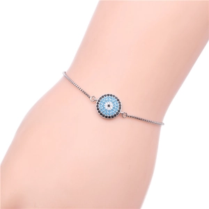 Macro detail of adjustable silver chain bracelet with micro-pave evil eye charm