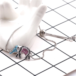 Detail of adjustable elephant charm bracelet with blue and red micro-set zircon stones
