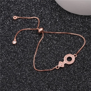 Macro shot of rose gold adjustable box chain bracelet with sparkling zircon key pendant