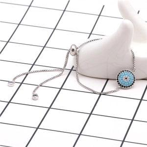 Detailed macro view of silver evil eye bracelet with blue micro zircons and adjustable sliding clasp