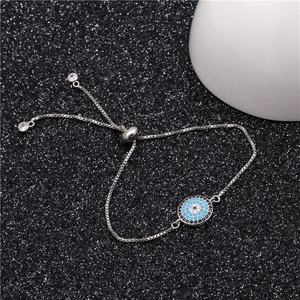 Macro detail of silver evil eye adjustable slider bracelet with micro-paved zircons