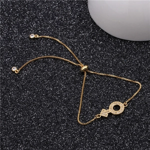 Macro detail of adjustable gold bracelet with micro-pave zircon male symbol pendant
