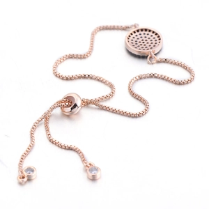 Detail of rose gold adjustable box chain bracelet with micro-pave cubic zirconia pendant