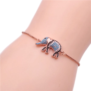 Close-up of rose gold elephant bracelet with micro-set blue and black crystals on wrist