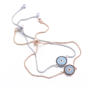 Detailed macro view of adjustable evil eye bracelets in silver and rose gold finishes