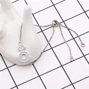 Macro shot of adjustable box chain bracelet with sparkling zircon pave Mars symbol pendant