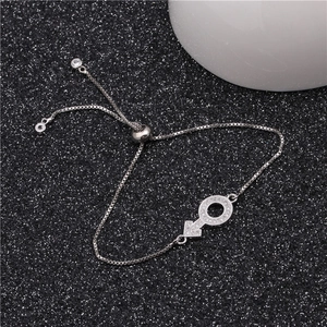 Detail of silver box chain bracelet with sparkling zircon male symbol and slider clasp