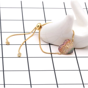 Adjustable gold heart bracelet with rainbow zircon pavé and central keyhole detail