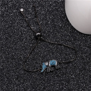 Detail of adjustable black chain bracelet featuring a turquoise elephant zircon pendant